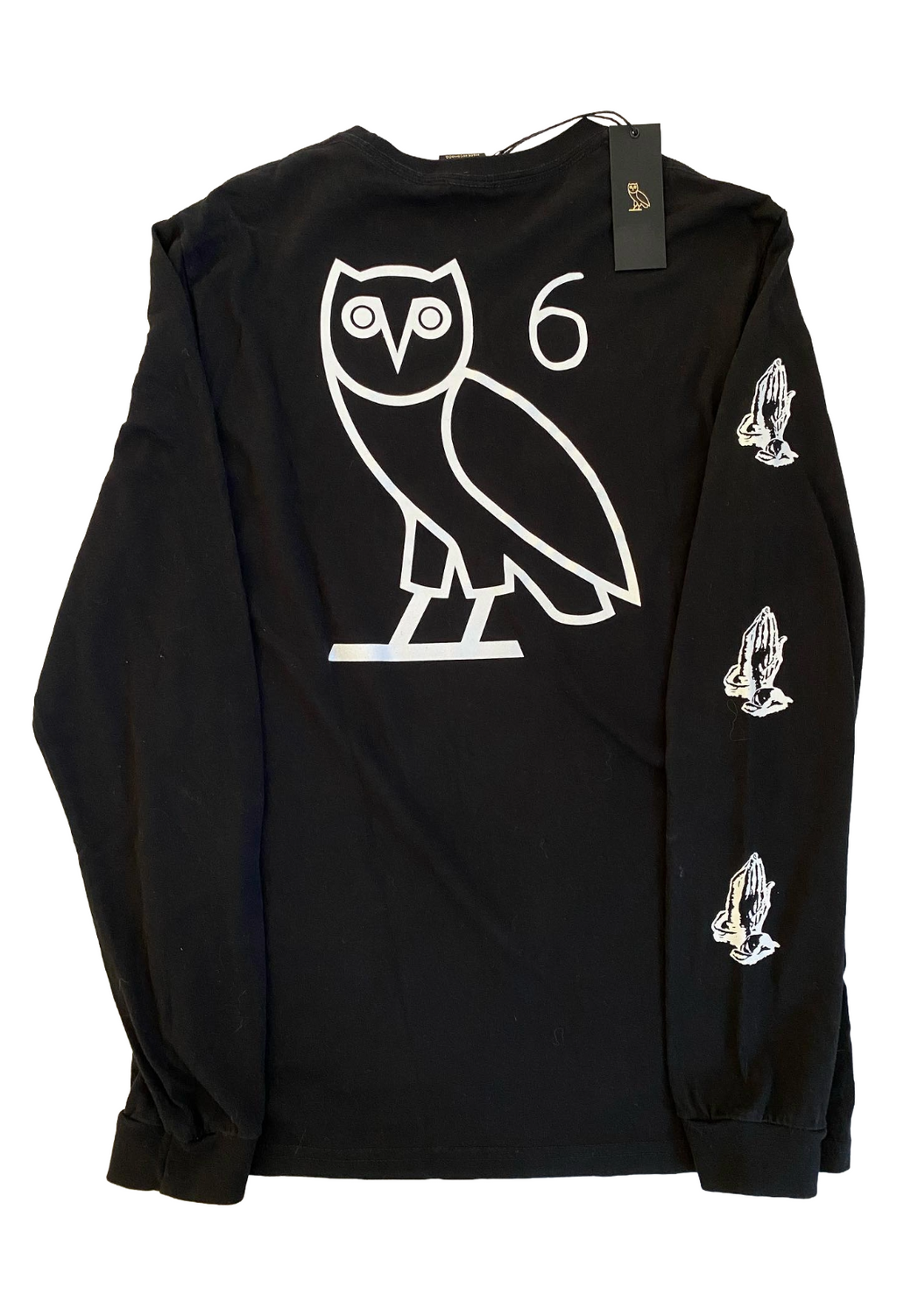 Black long-sleeve shirt with white owl logo and praying hands on a white background OVO 6 God Longsleeve Shirt