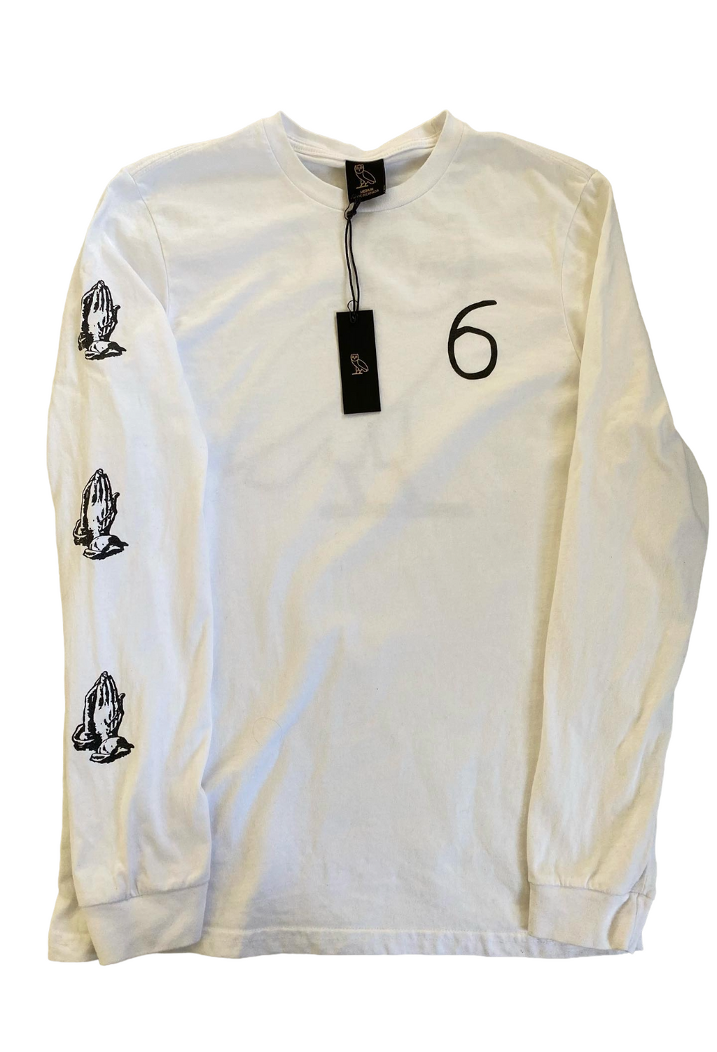 White long-sleeve shirt with black graphics and a tag displaying the number 6 on a white background OVO 6 God Longsleeve Shirt