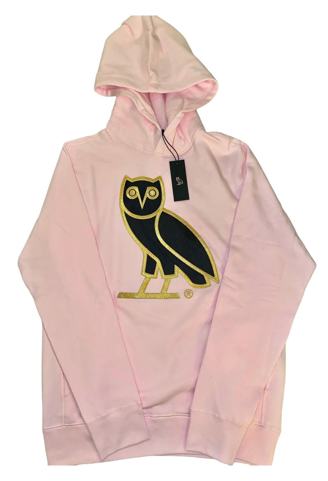 Pink hoodie with an owl logo and a tag on a white background OVO OG Owl Hoodie Pink 2021