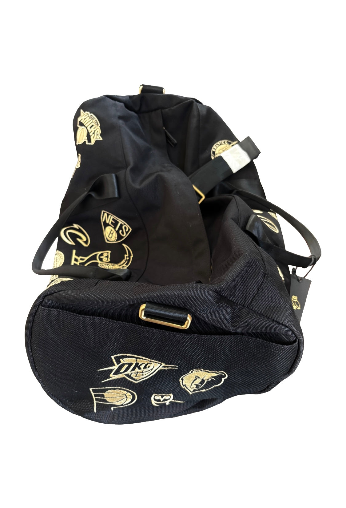 Black duffel bag with gold logos on a white background