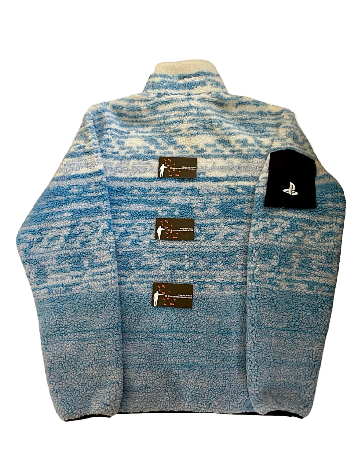 Blue patterned jacket with multiple brand labels on a white background