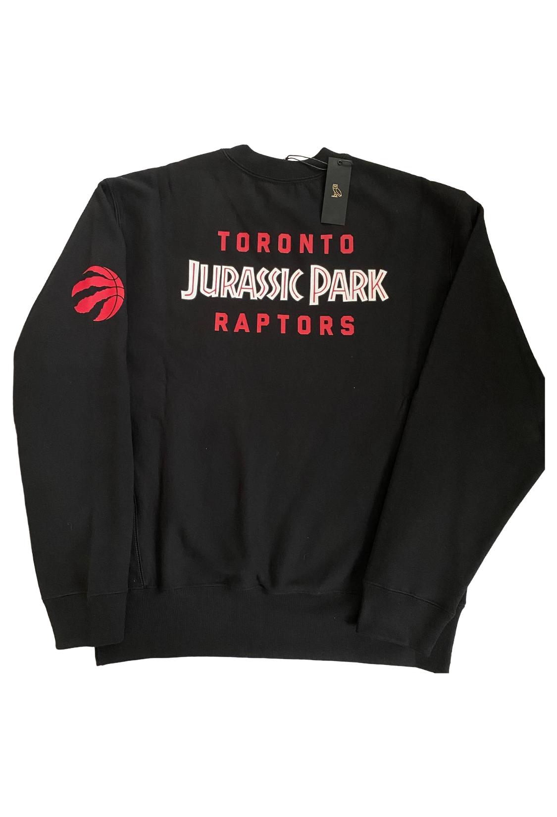 Black sweatshirt with 'Toronto Jurassic Park Raptors' text and logo on a white background. OVO X Toronto Raptors X Jurassic Park X Dino Shattered Backboard Crewneck