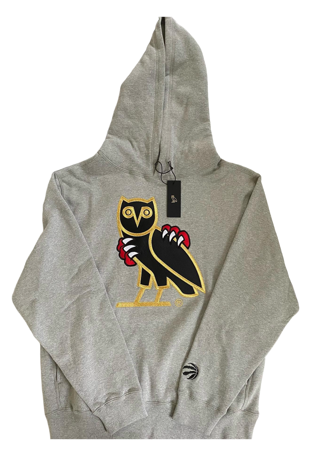Gray hoodie with a distinctive logo on a white background OVO x Jurassic Park x Raptors OG Owl Hoodie 2021