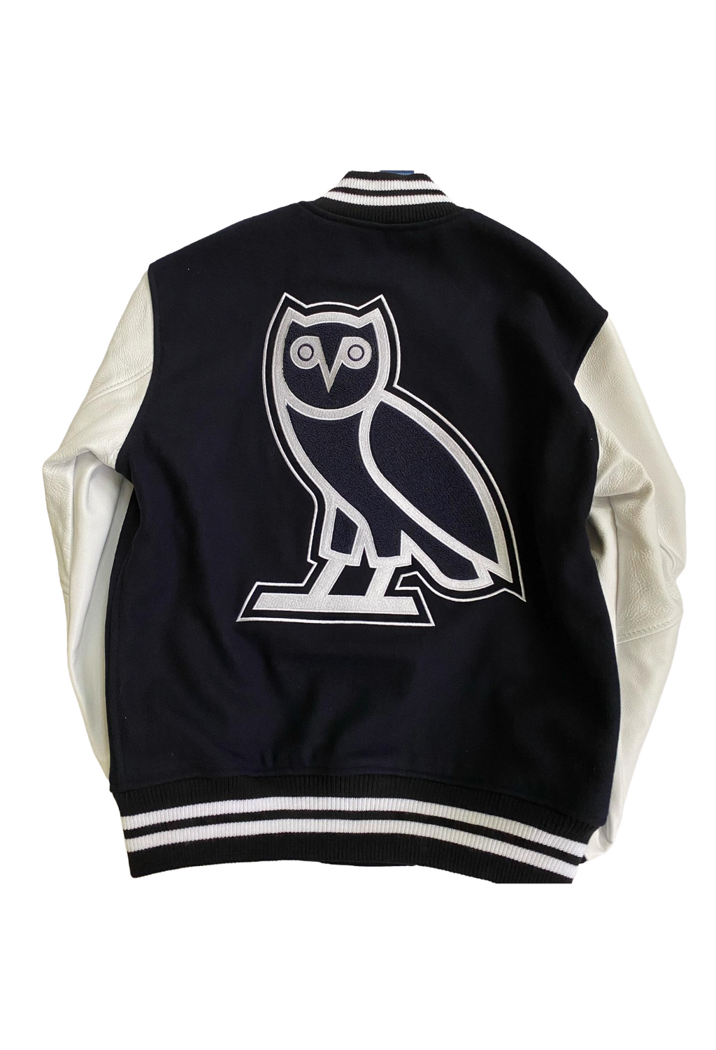 Black and white varsity jacket with an owl logo on a white background. OVO x UofT University of Toronto Leather Wool Varsity Jacket