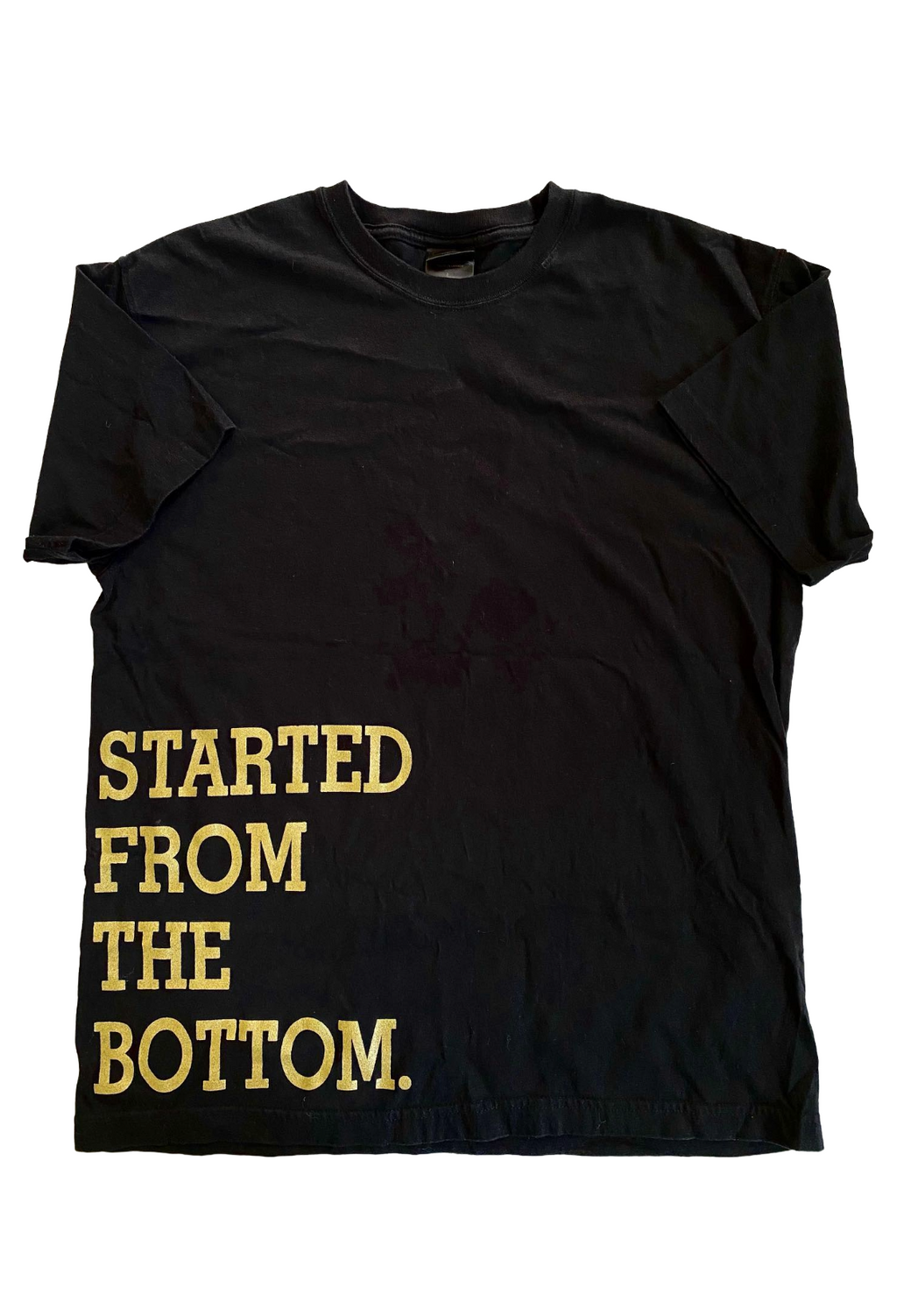 Black t-shirt with 'STARTED FROM THE BOTTOM.' text in gold on a white background. Started From The Bottom Bottom Tee 2013